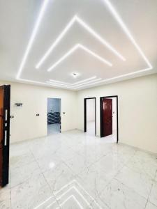 an empty room with white walls and a white tile floor at Cairo gust house in Alexandria