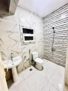 a bathroom with a toilet and a sink and a window at Cairo gust house in Alexandria