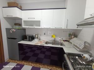 a small kitchen with a sink and a refrigerator at Sheki Dream House in Sheki +12 photos