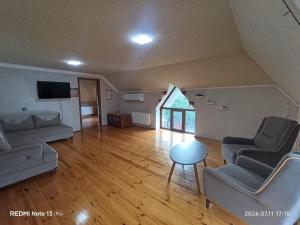 a living room with a couch and chairs and a table at Sheki Dream House in Sheki
