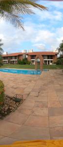 a resort with a swimming pool and a building at Casa Maravilha in Aquiraz