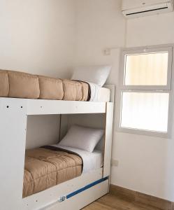 two bunk beds in a small room with a window at Casa de los Cerros I - Vaqueros in Vaqueros +12 photos