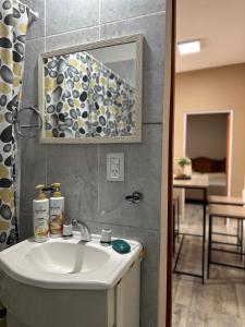 a bathroom with a sink and a mirror at Finca Alta Gracia La Banda in La Banda +7 photos