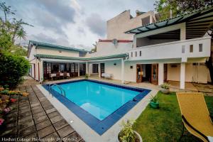 a house with a swimming pool in the yard at serendipty lake villa in Panadura