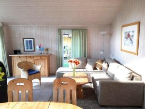 a living room with a couch and a table at Ferienhaus mit Sauna im Ferienpark Mirow in Granzow