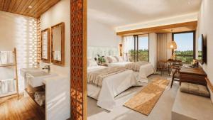 a bedroom with a bed and a bathroom with a sink at Beach Park Resort - Ohana in Aquiraz +19 photos