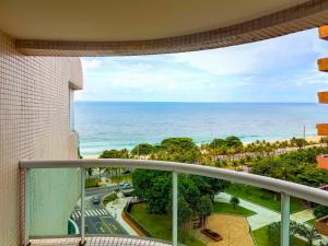 a balcony with a view of the ocean at Wyndham Rio Barra - Oficial in Rio de Janeiro