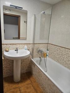 a bathroom with a sink and a shower and a tub at Villa Sojuela Green in Sojuela +25 photos