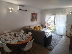 a living room with a table and a couch at Imperial Tarraco Apartment in Tarragona