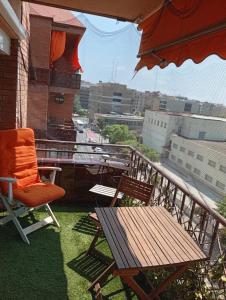 a balcony with a chair and a table and an umbrella at Imperial Tarraco Apartment in Tarragona