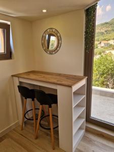a room with a desk with two chairs and a mirror at 2 4 D2 Mini Condos Studio Loft West facing in Tivat