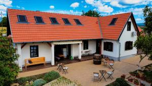 an aerial view of a house with an orange roof at Limbus Fogadó in Gyöngyöstarján