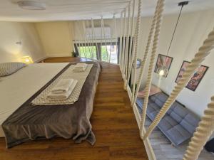 a bedroom with a bed and a swing at 2 4 D2 Mini Condos Studio Loft West facing in Tivat