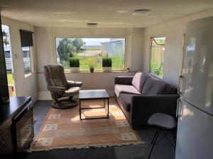 a living room with a couch and two chairs at Arrie in in Vellinge