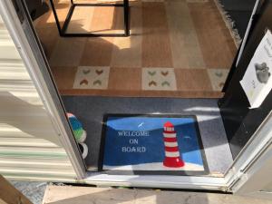 a welcome on a board sign on a floor at Arrie in in Vellinge