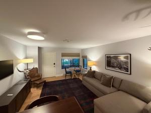 a living room with a couch and a table at Telluride Creekside Condo 3 Min to Chair 7 in Telluride