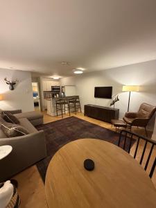 a living room with a couch and a table at Telluride Creekside Condo 3 Min to Chair 7 in Telluride