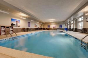 a large swimming pool with blue water in a building at Drury Plaza Hotel Cincinnati Florence in Florence