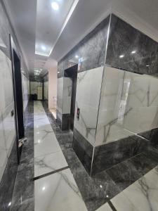 a lobby with marble floors and a glass wall at Daire 1 in Gazipasa +8 photos