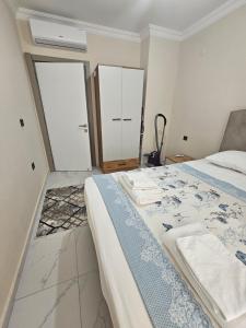 a bedroom with a bed and two white cabinets at Daire 1 in Gazipasa
