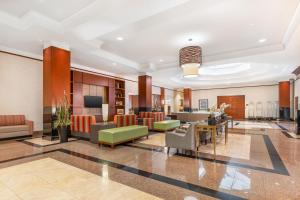 a lobby of a hotel with chairs and tables at Drury Inn & Suites St. Louis Forest Park in Saint Louis