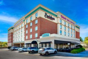 a hotel with cars parked in a parking lot at Drury Inn & Suites St. Louis Forest Park in Saint Louis