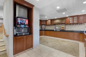 a kitchen with a drink bar with a cocacola machine at Drury Inn & Suites Joplin in Joplin