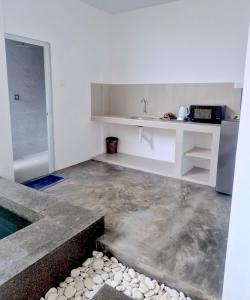 a kitchen with a concrete floor and a sink at Altura Esthetic Villas in Bokor