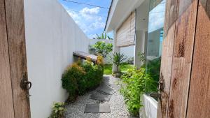 a pathway leading to a house with a door open at Altura Esthetic Villas in Bokor