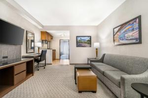 a living room with a couch and a table at Drury Plaza Hotel Flagstaff in Flagstaff