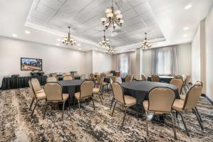 a conference room with tables and chairs and a stage at Drury Plaza Hotel Flagstaff in Flagstaff +53 photos