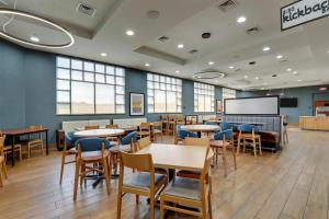 a dining room with tables and chairs and a chalkboard at Drury Inn & Suites Montgomery in Montgomery