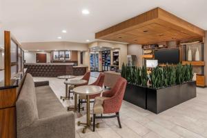 a lobby with chairs and tables and a tv at Drury Plaza Hotel Columbus Downtown in Columbus