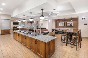 a living room with a kitchen and a dining room at Drury Plaza Hotel Columbus Downtown in Columbus