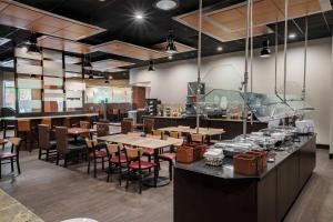 a restaurant with tables and chairs and a bar at Drury Plaza Hotel New Orleans in New Orleans