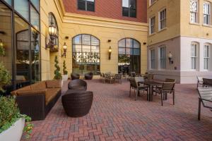 a patio with tables and chairs in a building at Drury Plaza Hotel New Orleans in New Orleans