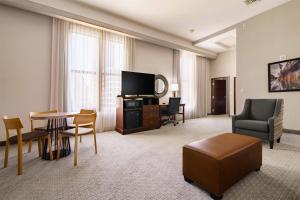 a hotel room with a television and a table and chairs at Drury Plaza Hotel New Orleans in New Orleans