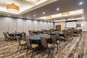 a conference room with tables and chairs and a screen at Drury Plaza Hotel New Orleans in New Orleans +88 photos
