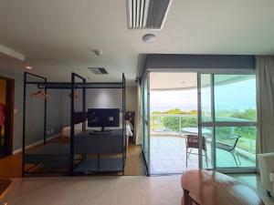 a living room with a sliding glass door to a balcony at Wyndham Rio Barra - Oficial in Rio de Janeiro +230 photos