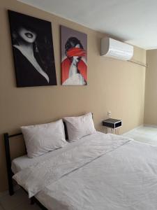 a bedroom with a bed with two pictures on the wall at Pendik ar Marmaray Pet Friendly in Istanbul