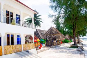a row of houses on the beach at Visitors Inn Zanzibar in Jambiani