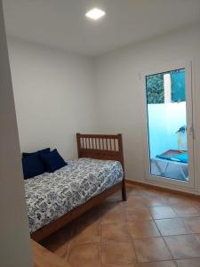 a bedroom with a bed and a window at Playa de Mogán in Playa del Cura