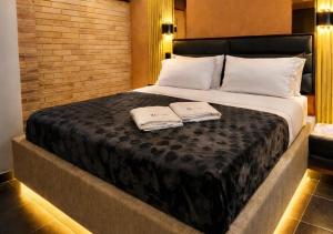 a bedroom with a large bed with two towels on it at Hotel Biba Life - Chia in Chía +21 photos