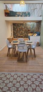 a wooden table and chairs in a room at La mie du Hom in Thury-Harcourt