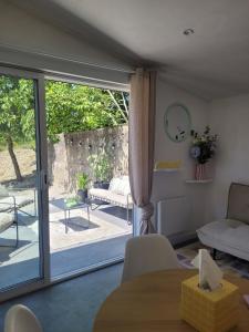 a living room with a sliding glass door at Le cocon du pas de Lauzens in Aouste-sur-Sye