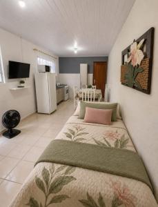 a bedroom with a large bed in a room at Residencial Nereu in Bombinhas