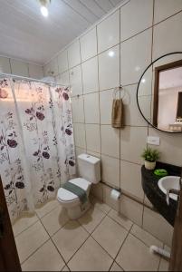 a bathroom with a toilet and a sink at Residencial Nereu in Bombinhas +41 photos