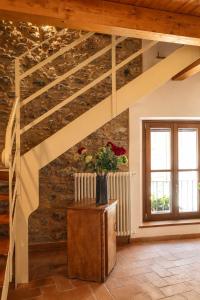 a room with a stone wall with a wooden ceiling at Casa Il Borgo 1 in Tavernelle +9 photos