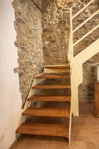 a staircase in a room with a stone wall at Casa Il Borgo 1 in Tavernelle