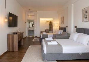 a bedroom with a bed and a couch and a living room at Grecia's Dhermi in Dhërmi
